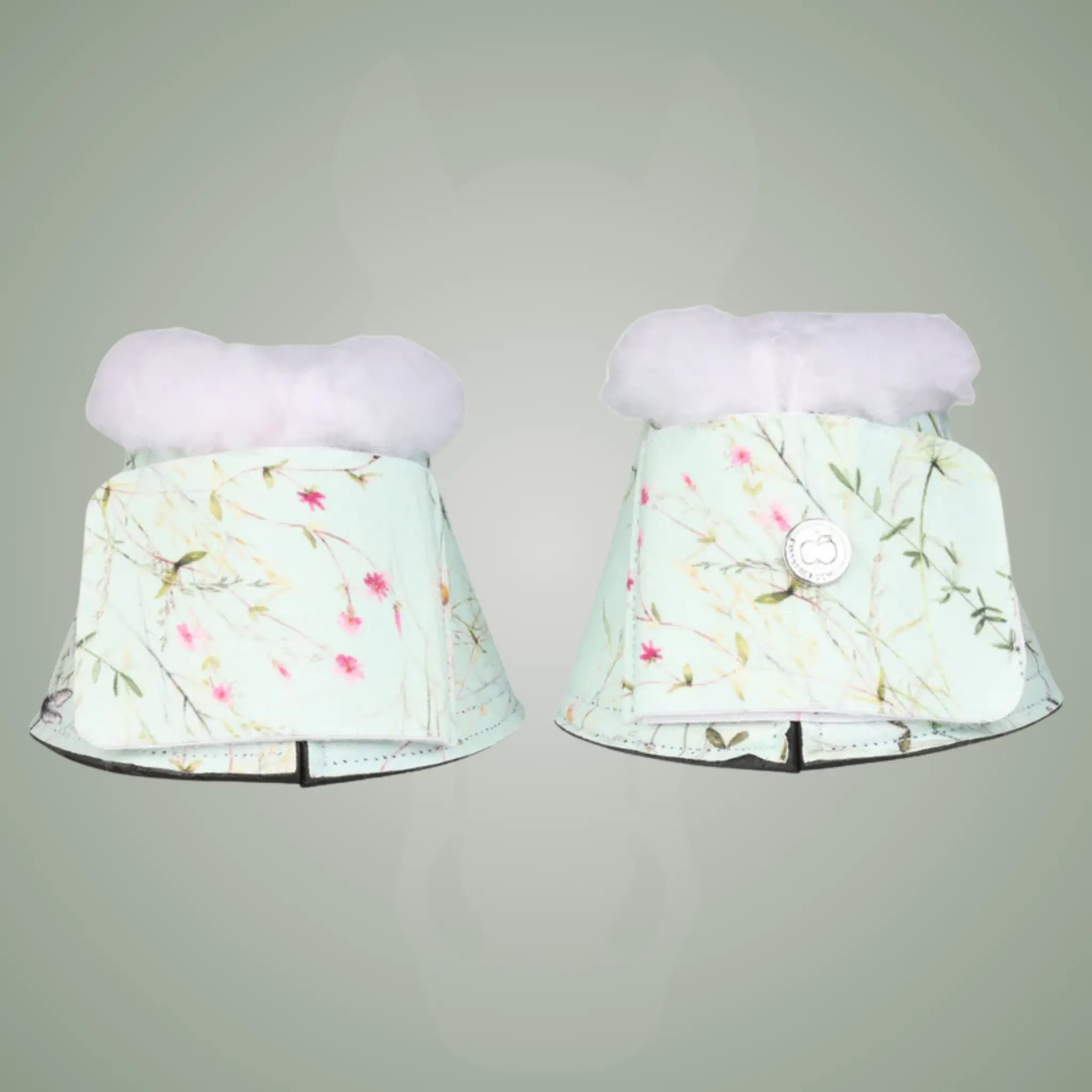 Pair of floral-patterned bell boots on a gray background