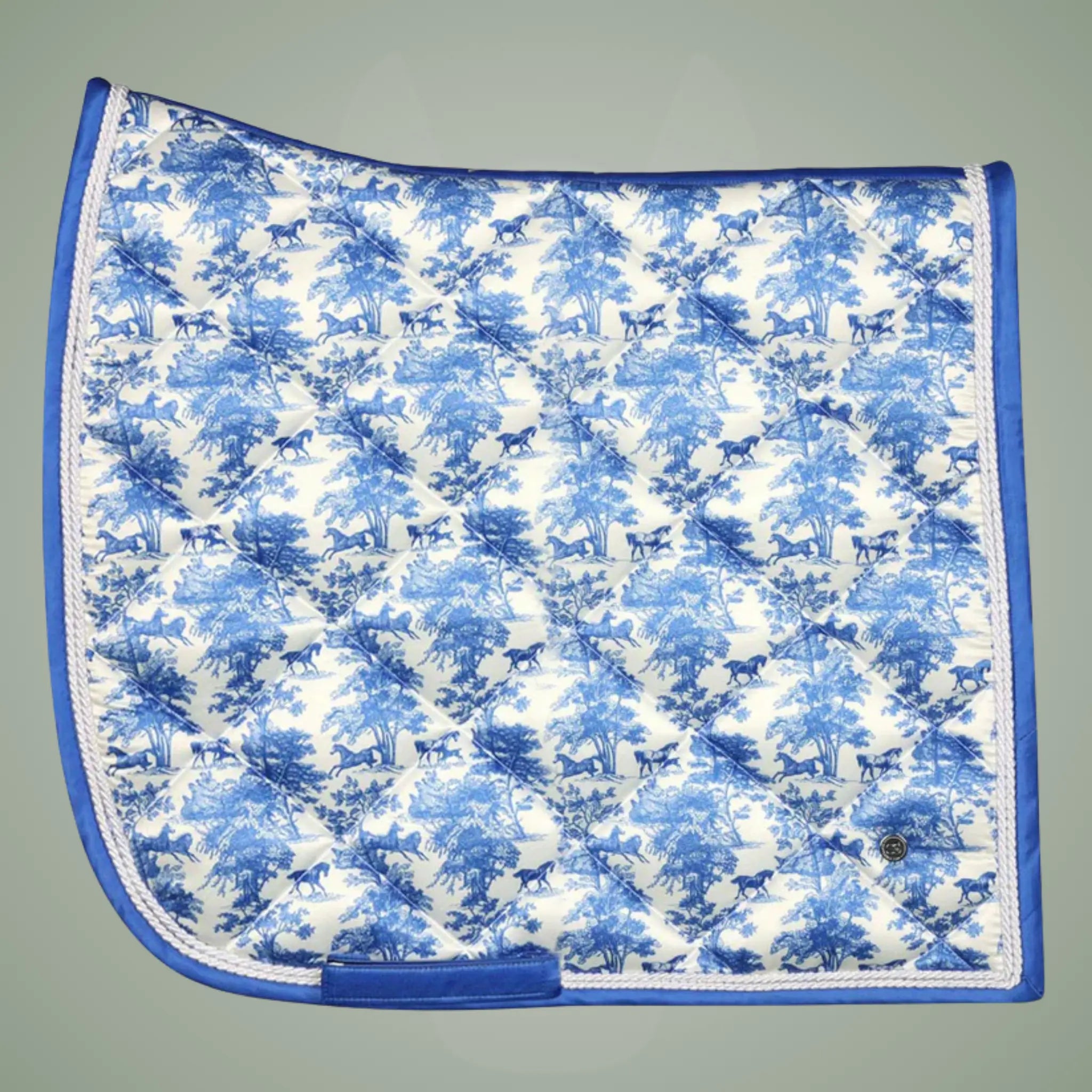 Saddle pad with blue and white horse pattern on a gray background