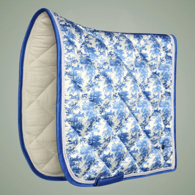 Blue and white quilted saddle pad on a gray background