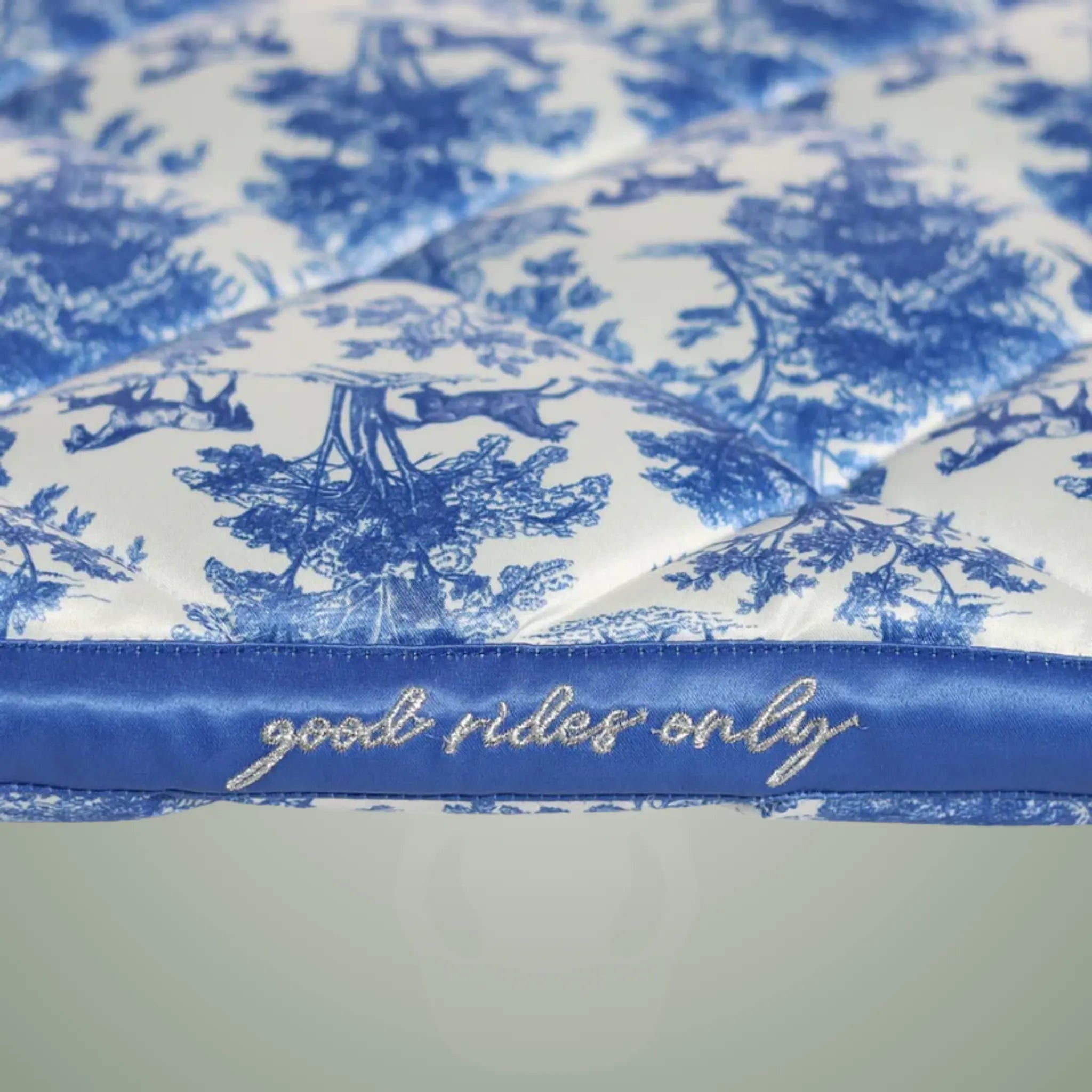 Blue and white patterned fabric with 'good rides only' text on a white background