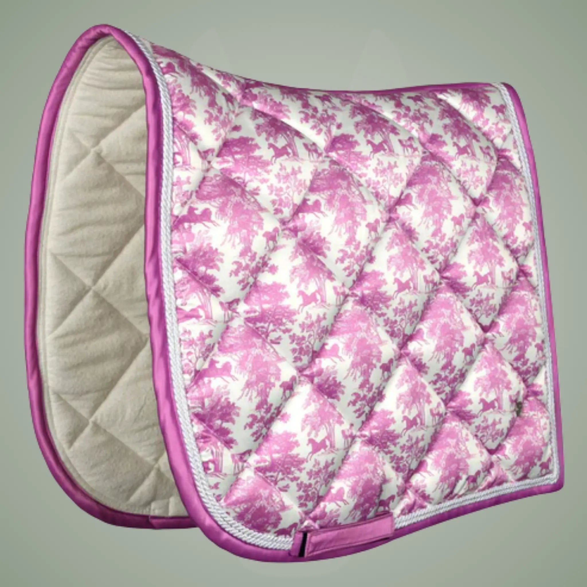 Pink floral patterned saddle pad on a gray background