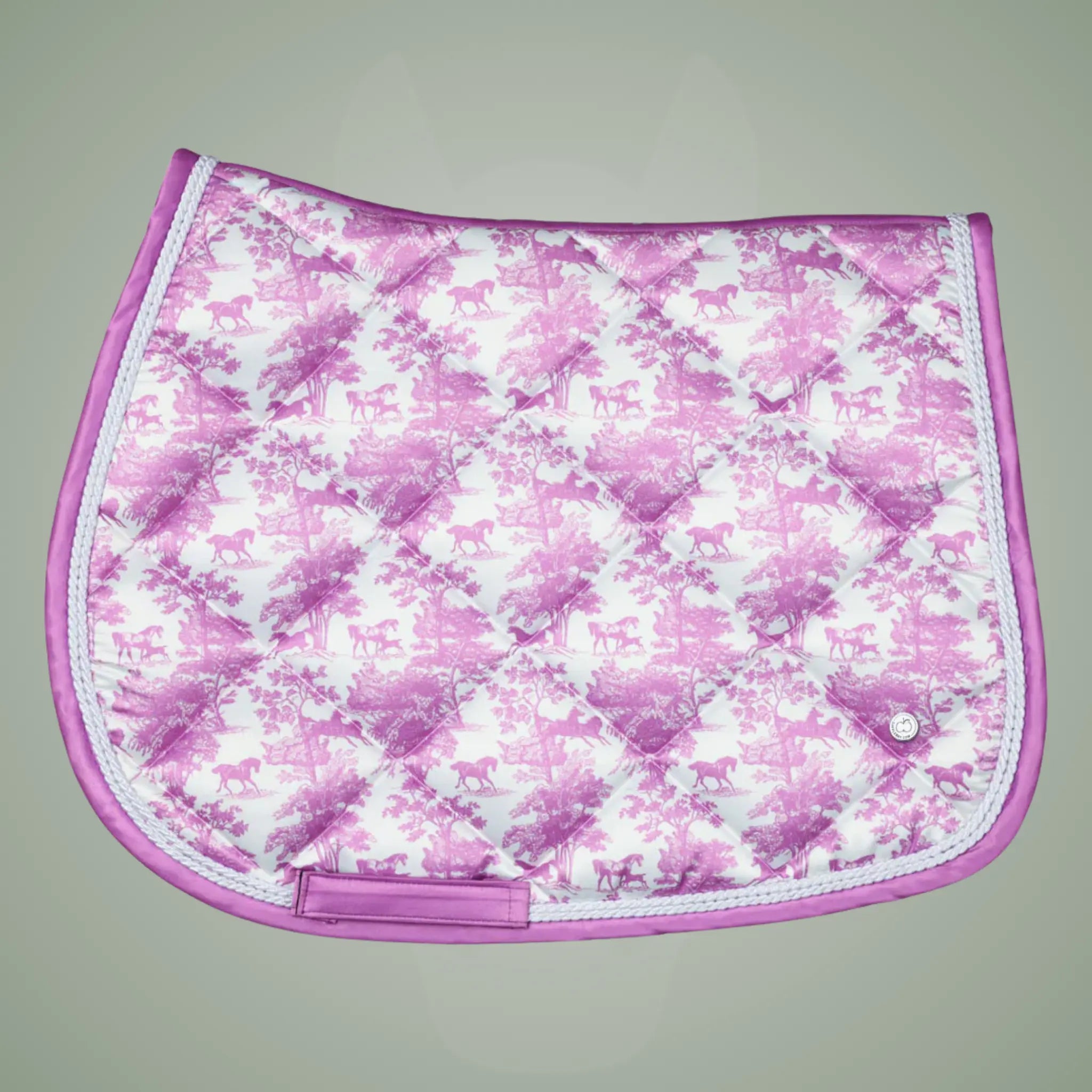 Pink and white patterned saddle pad on a gray background