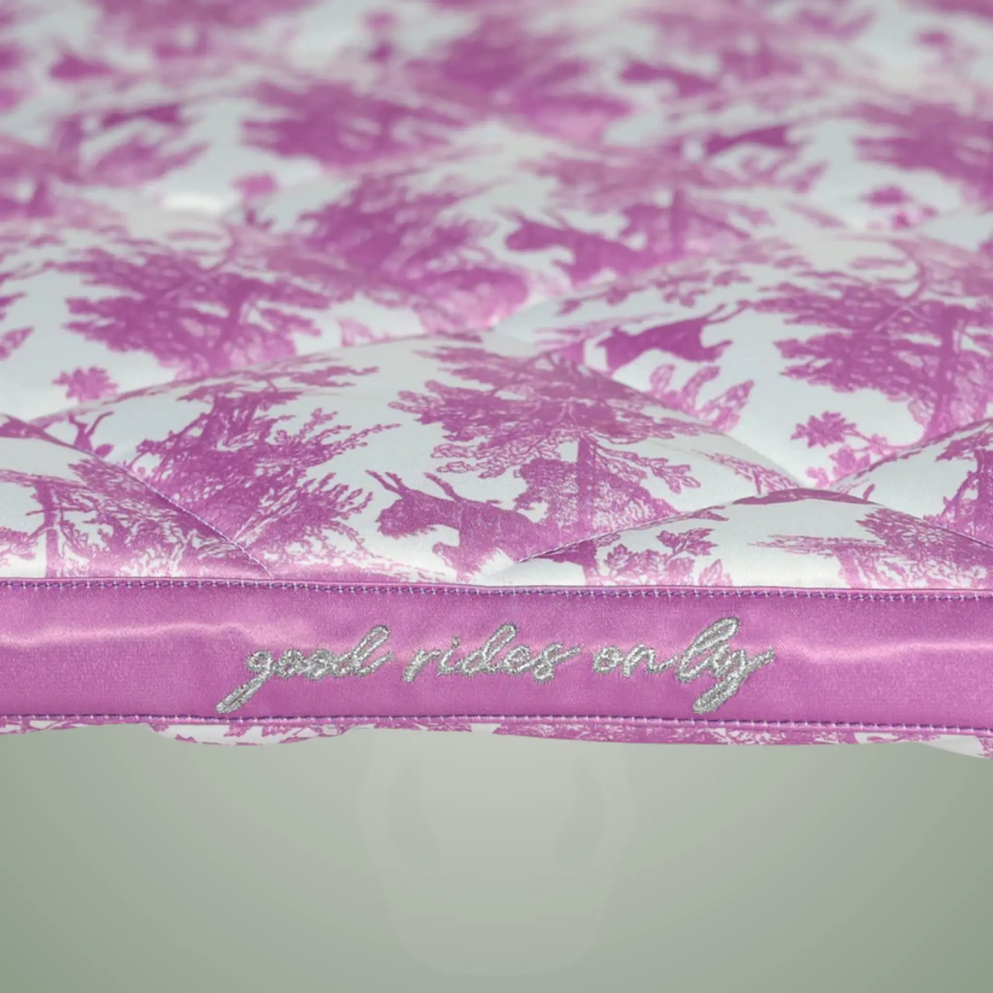 Pink and white patterned product with 'good rides only' text on a light gray background