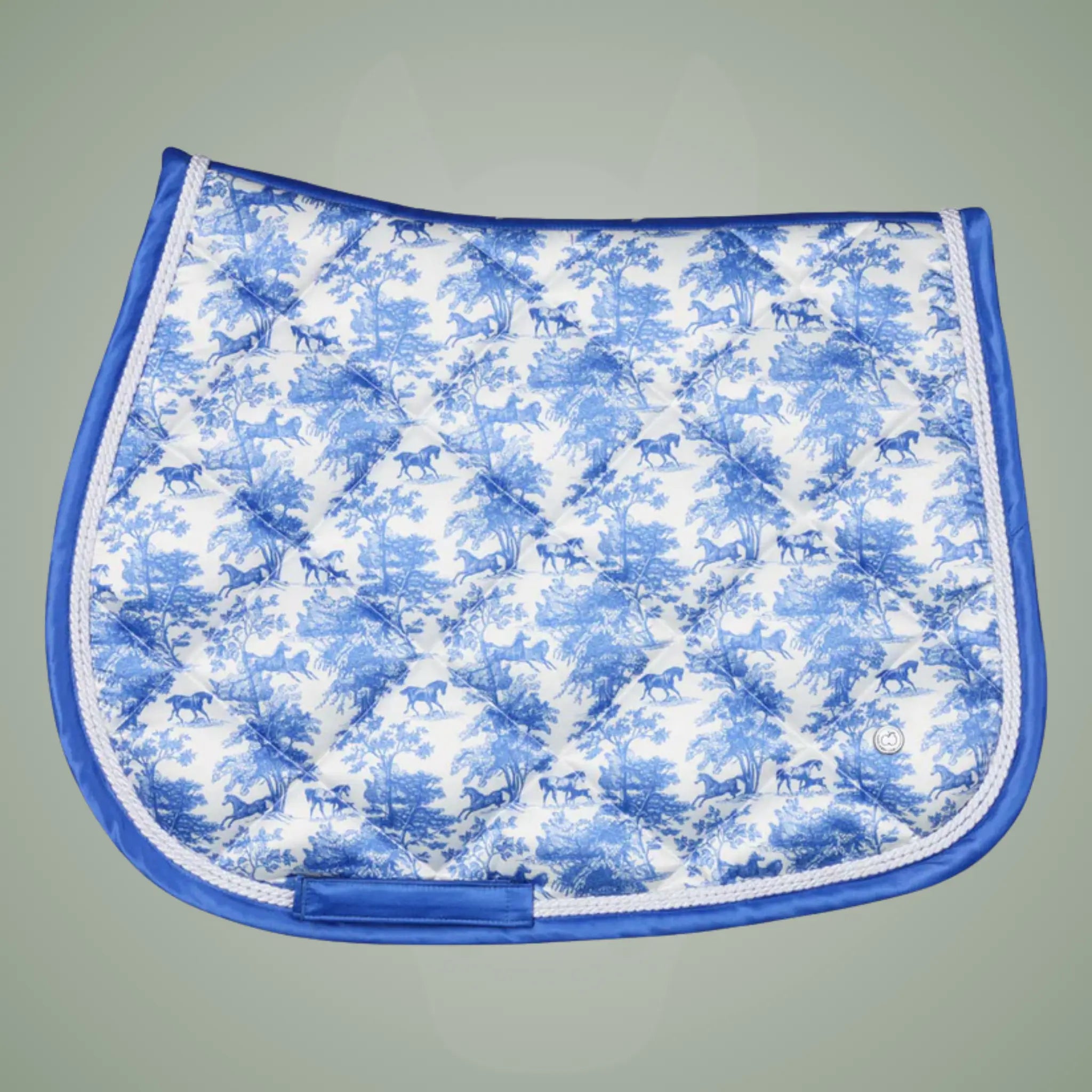 Blue and white patterned saddle pad on a gray background