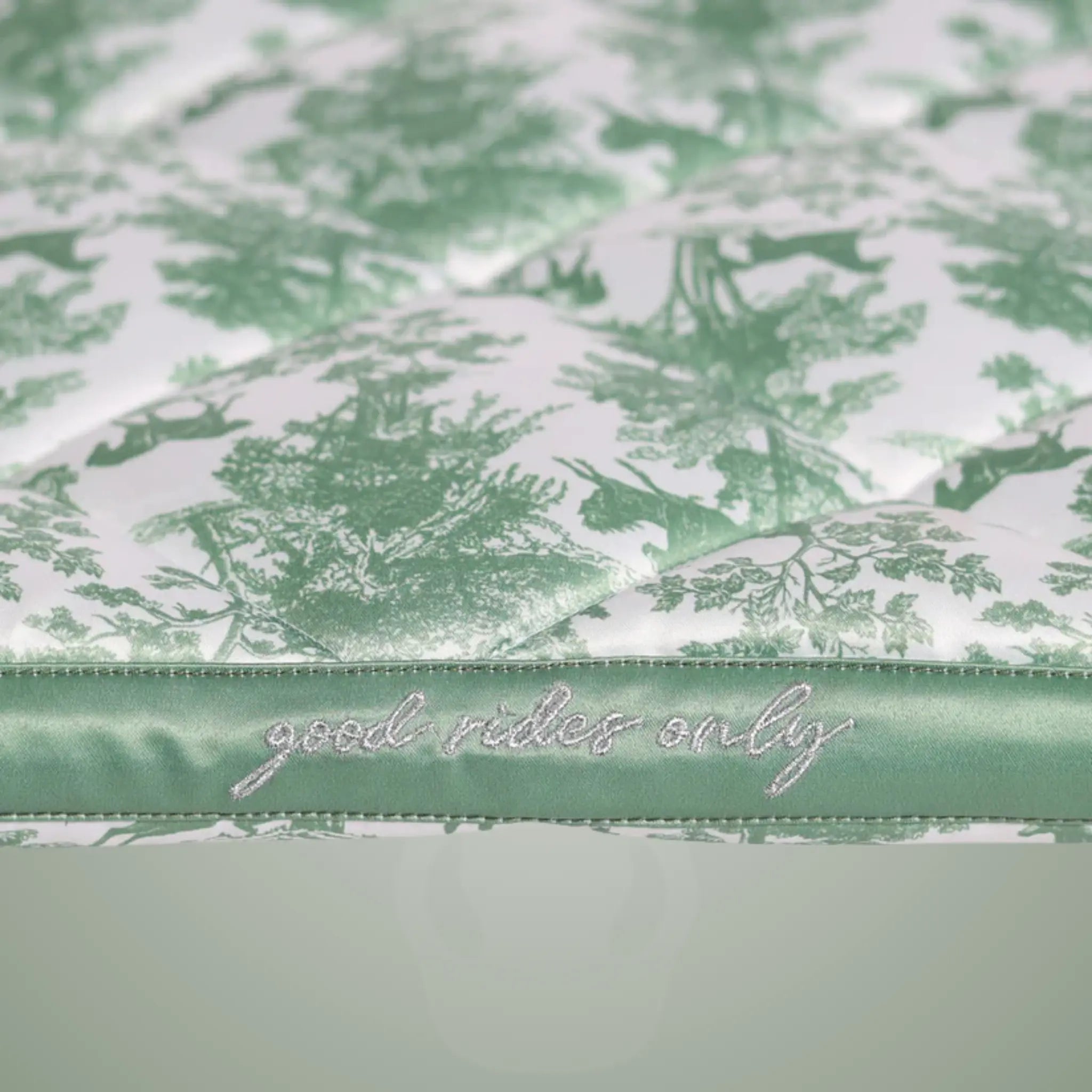 Green floral patterned product with 'good rides only' text on a green border
