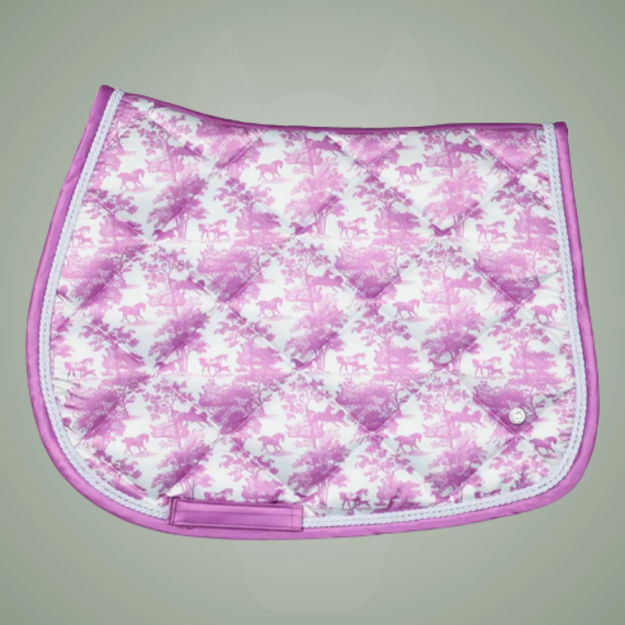 Pink and white floral patterned saddle pad on a gray background