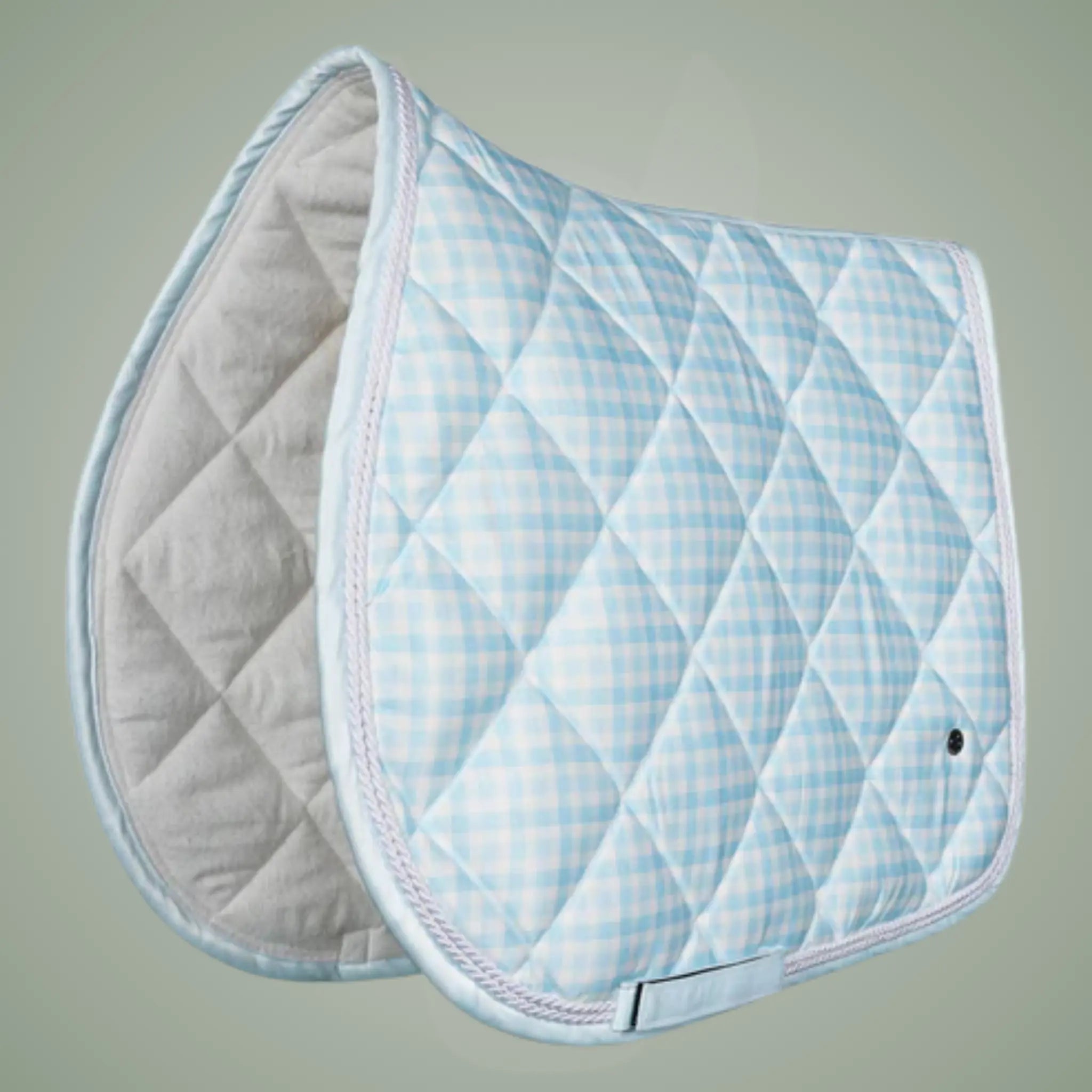 Quilted saddle pad with blue and white checkered pattern on a gray background