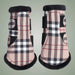 Pair of plaid horse boots with black trim on a light gray background