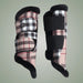 Pair of plaid horse leg wraps on a light gray background