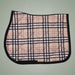 Plaid patterned saddle pad on a plain background