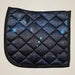 Quilted saddle pad with starry night design on a beige background