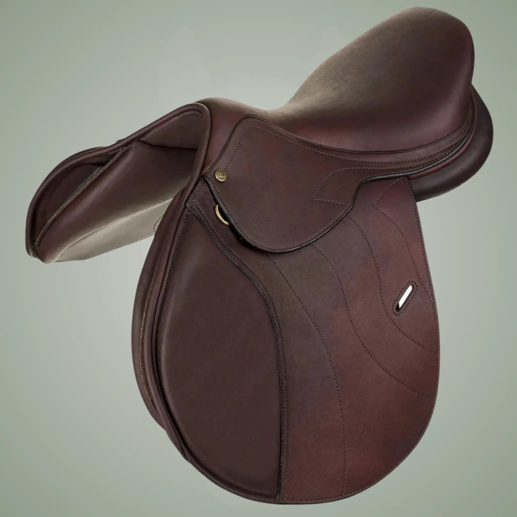 Brown leather saddle on a light gray background