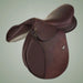 Brown leather saddle on a light gray background