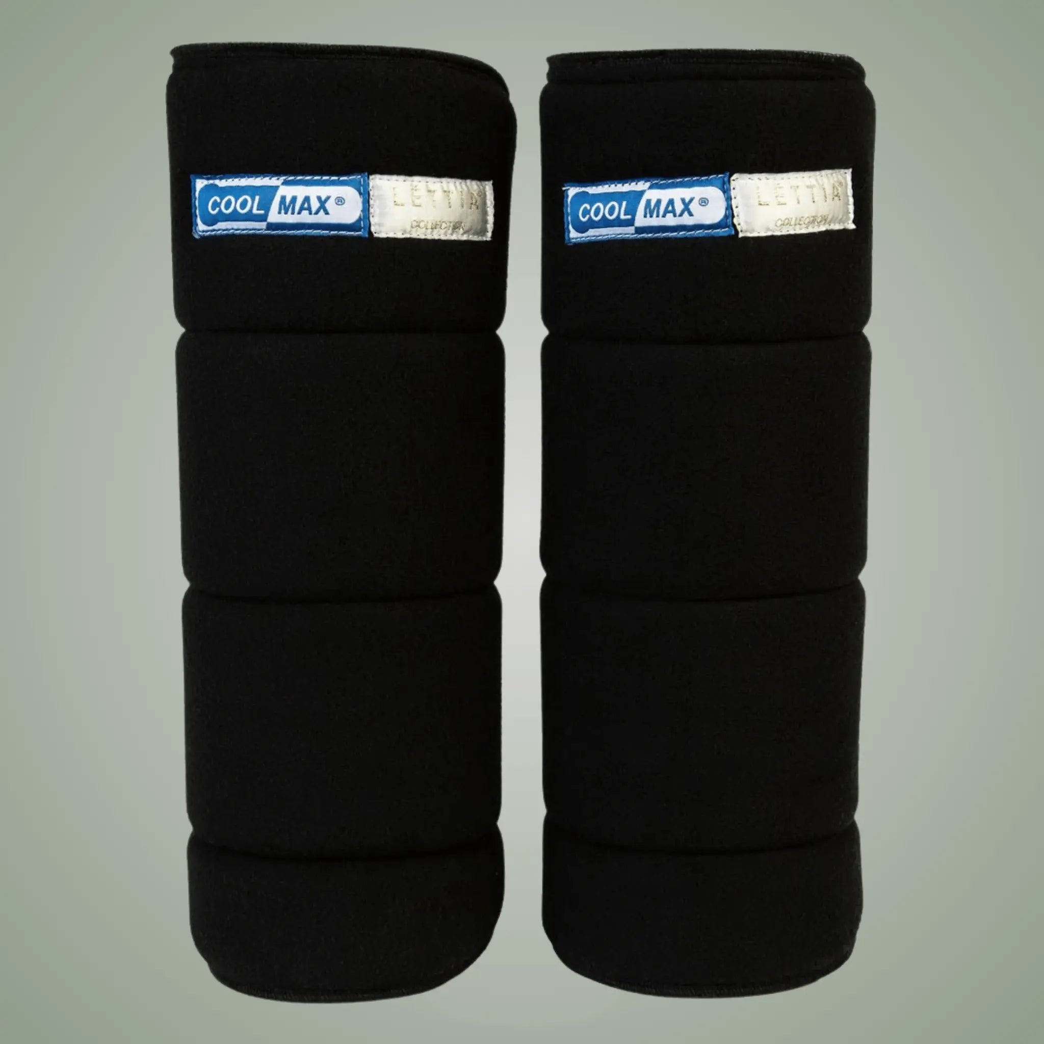 Pair of black leg wraps with Cool Max labels on a gray background
