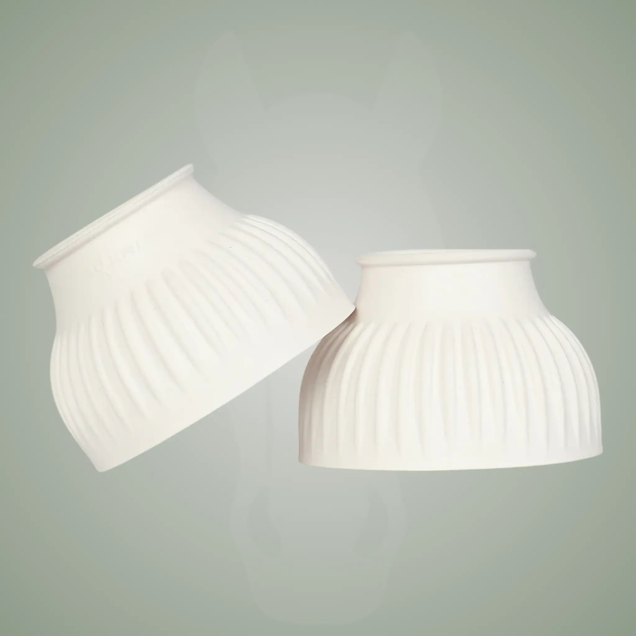 Two white ribbed lampshades on a light gray background