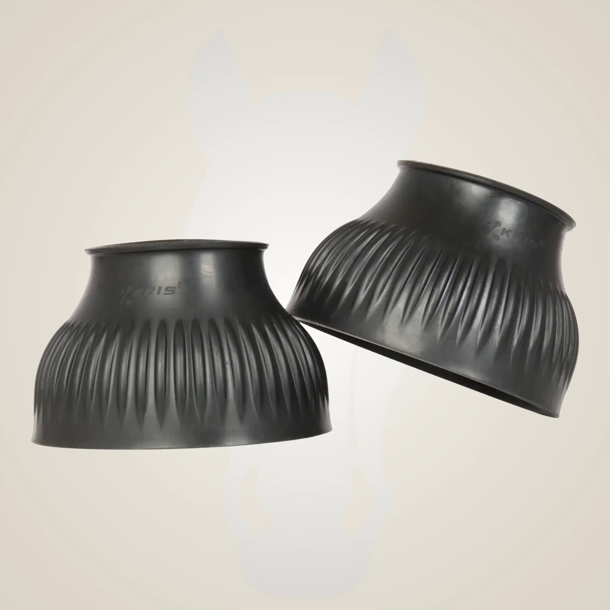 Two black rubber cups with ribbed texture on a beige background