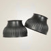 Two black rubber cups with ribbed texture on a beige background