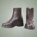 Pair of brown leather boots with zippers on a light green background