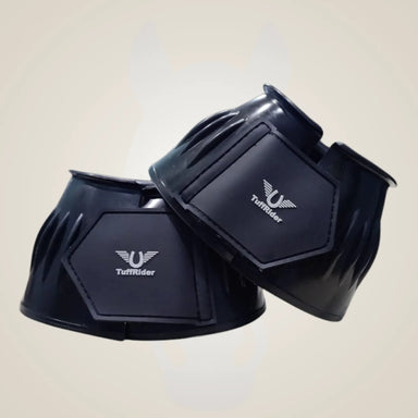 Black horse boots with TuffRider logo on a beige background